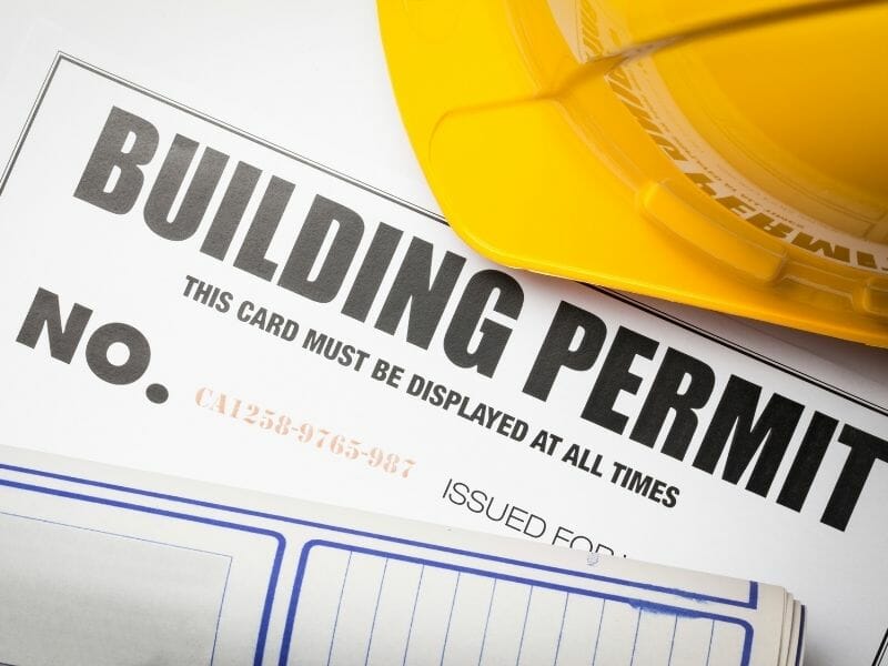 building permit and yellow hardhat