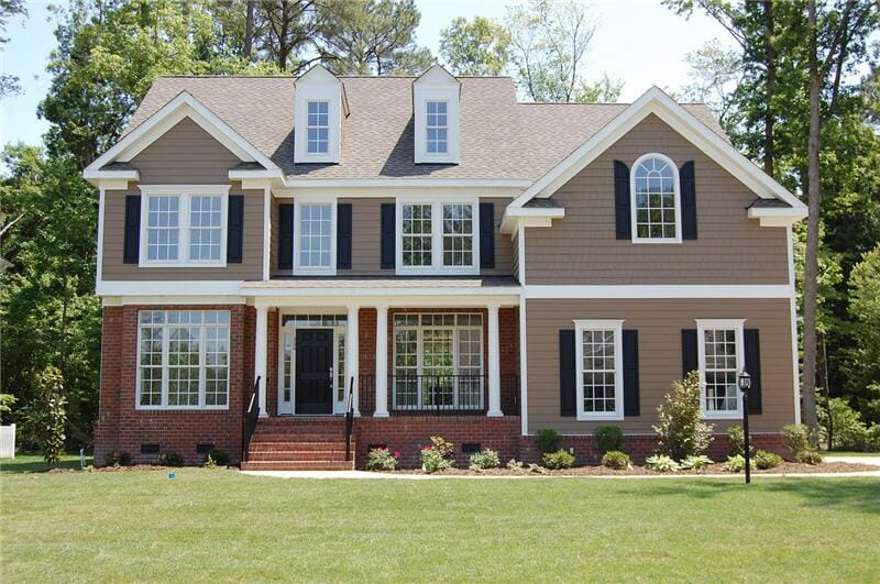 Farmhouse style home with lawn